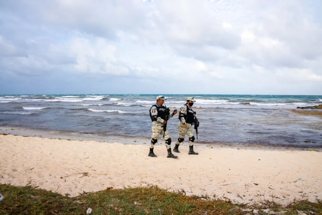 Military Soldiers Patrolling a Beach in Tulum, Mexico