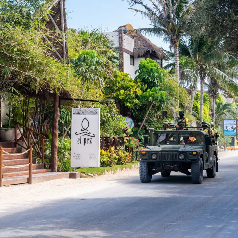 Military Vehicle Driving Down a Street in Tulum, Mexico