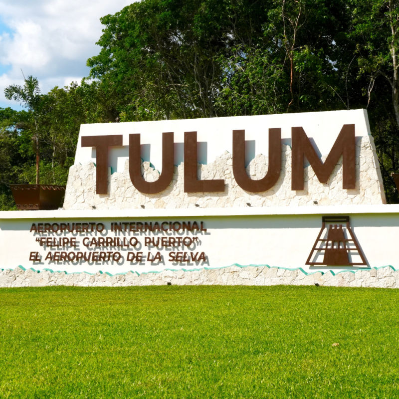 Green Lawn and Sign In Front of Tulum Internatinal Airport