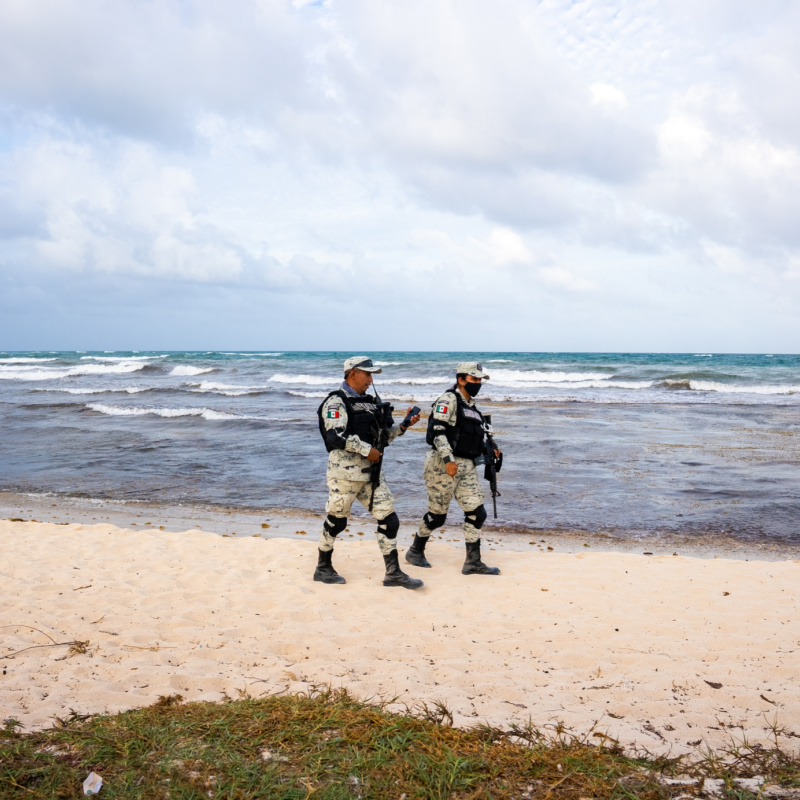 Military Soldiers Patrolling a Beach in Tulum, Mexico