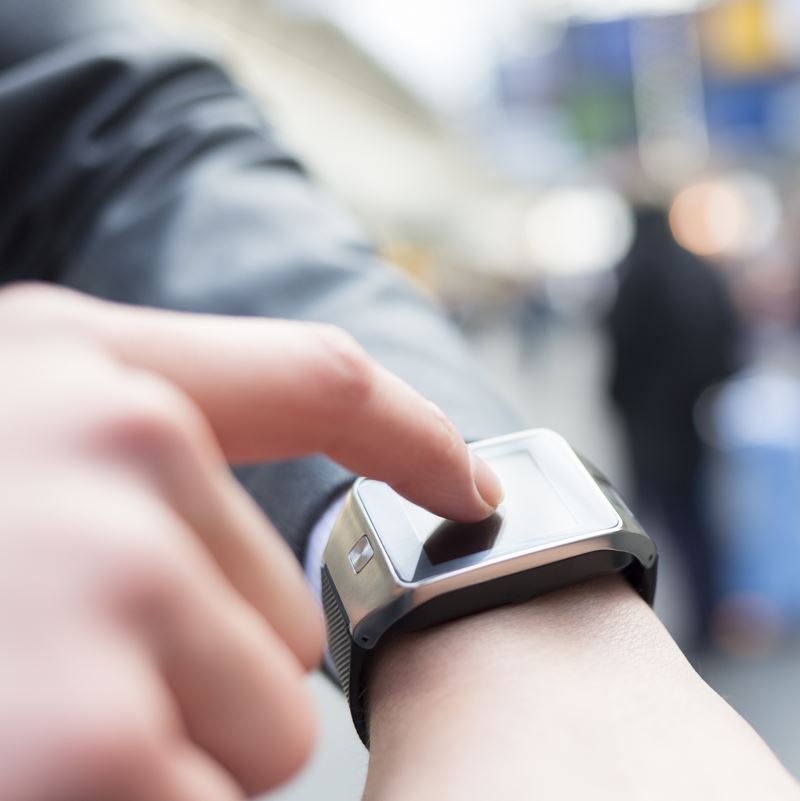 a smartwatch on a persons wrist being used