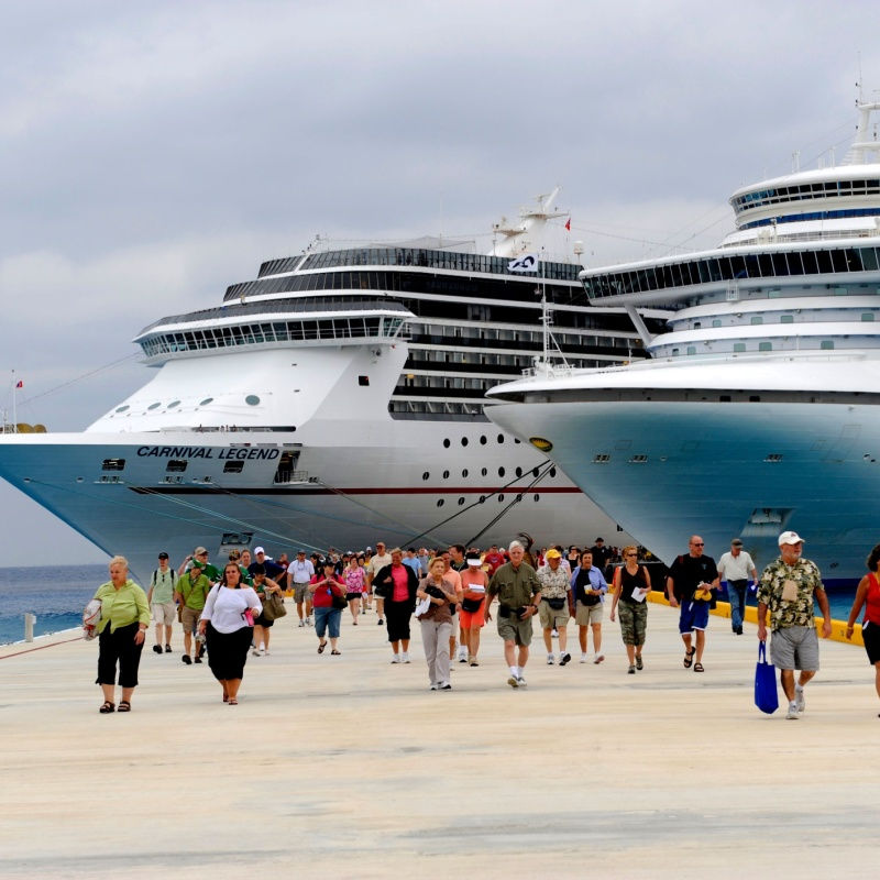 travelers walking away from a cruise ship in cozumel 