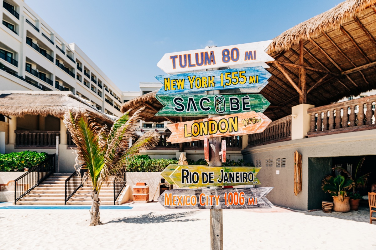 Wood sign at sandy Cancun beach resort