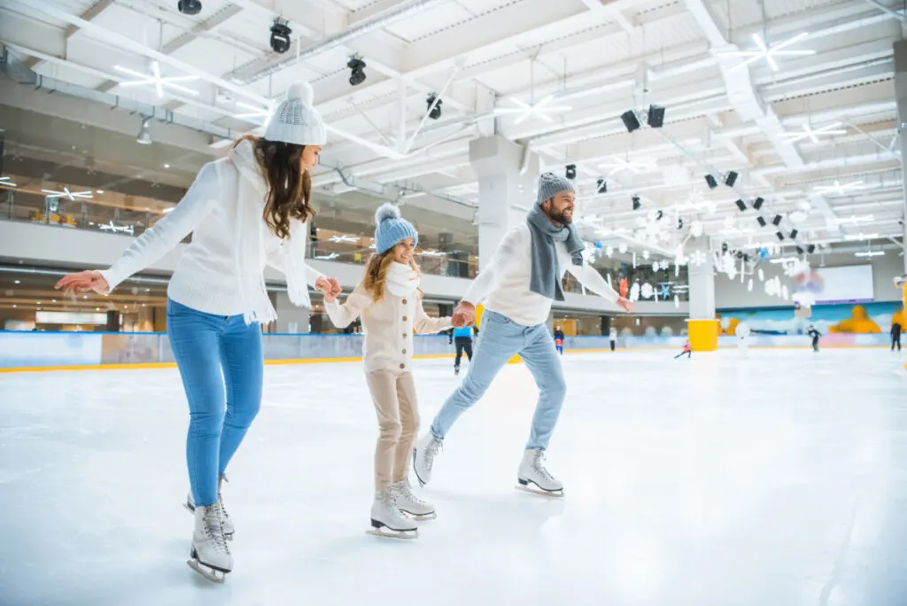 Family Ice SkatingTogether on an Inside Ice Skating Rink