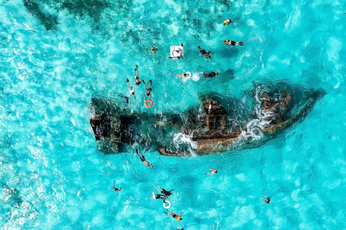 Cancun travelers snorkeling next to a ship