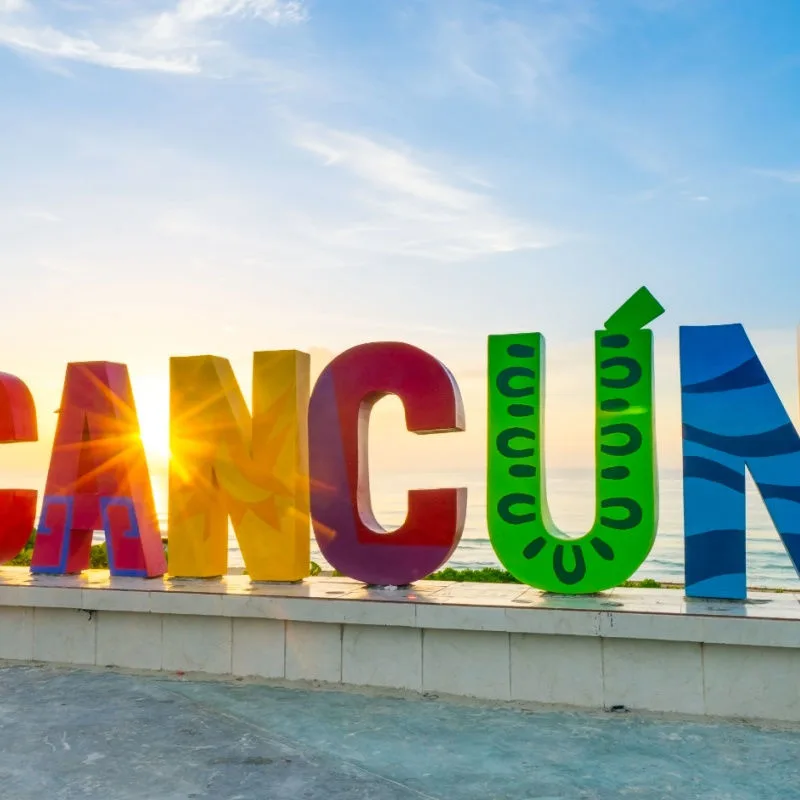 colorful cancun sign with sun 