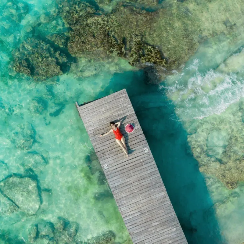 a young traveler lying on a pier in the Mexican Caribbean 