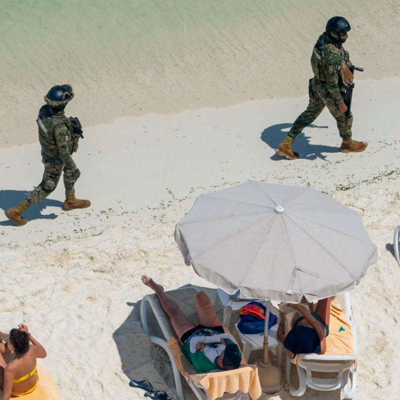 police officers walking on public beach in cancun 