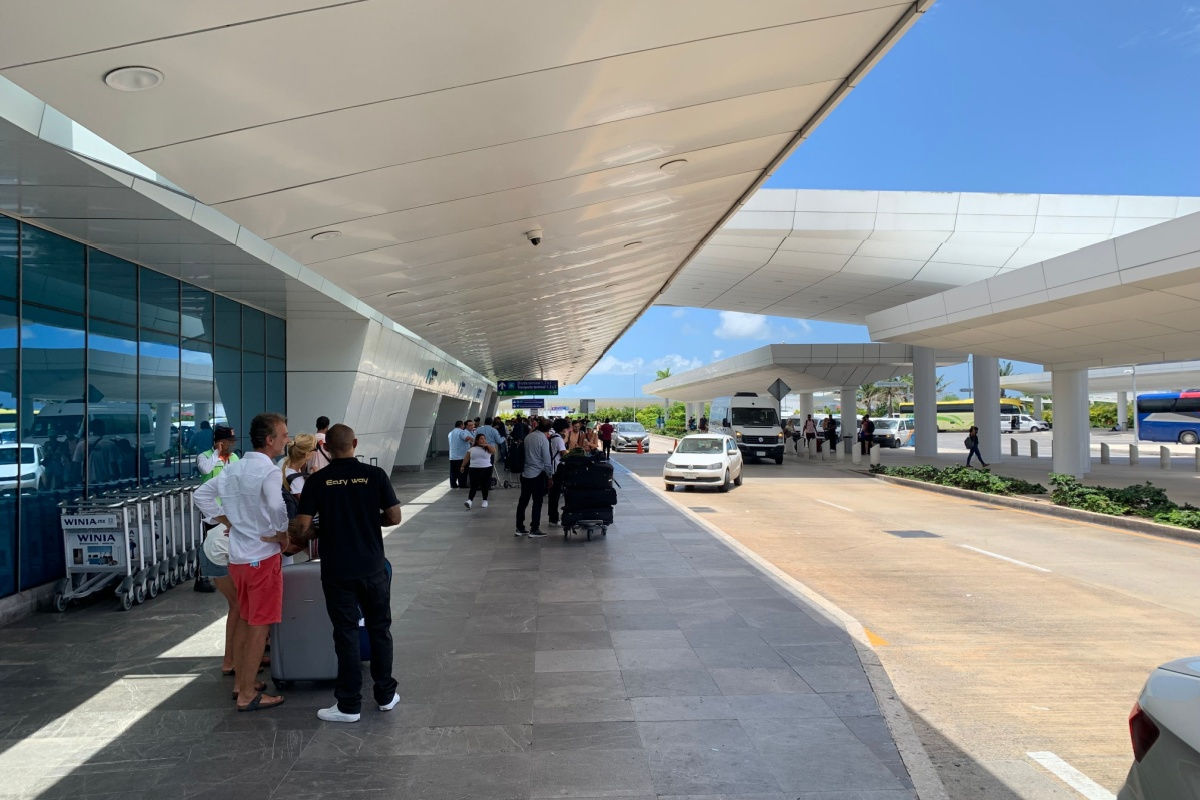 Outside view of Cancun airport terminal with taxis 