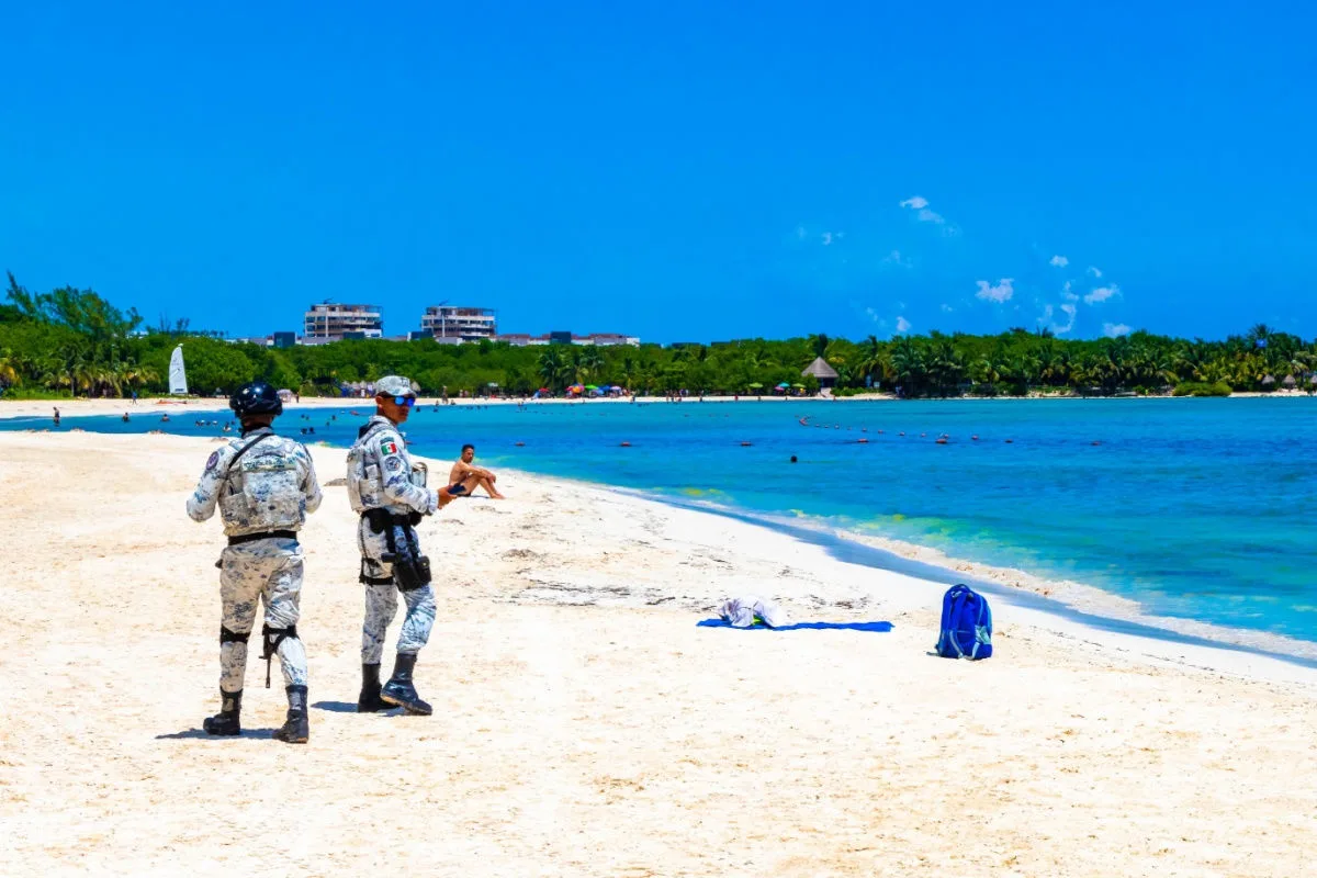 mexican military officers on a beach in cancun