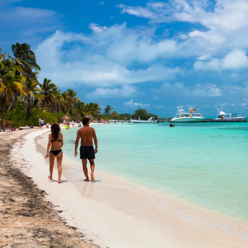 Tourists Walking on a Cancun Beach on a Beautiful Summer Day