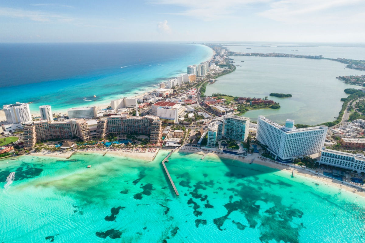 aerial view of a white sand beach in cancun with resorts 