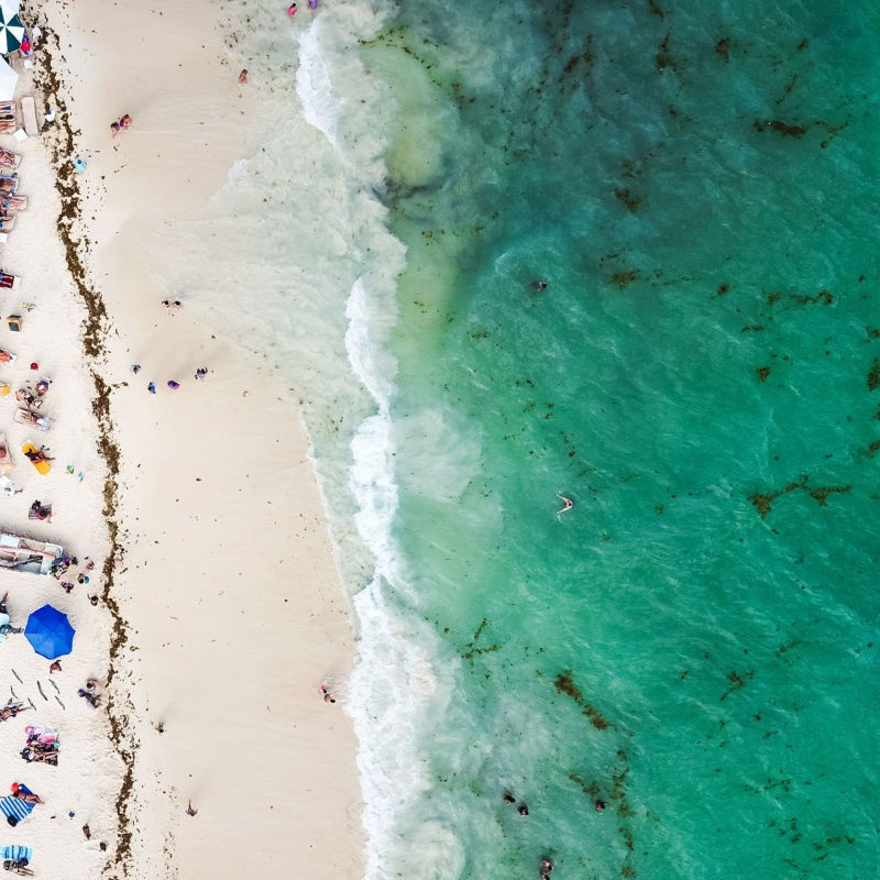 aerial view of a large white sand beach in playa del carmen 