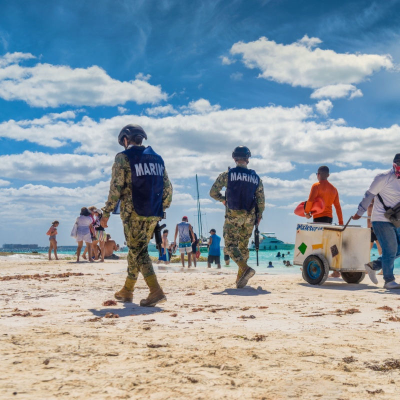 police officers on a busy cancun beach 