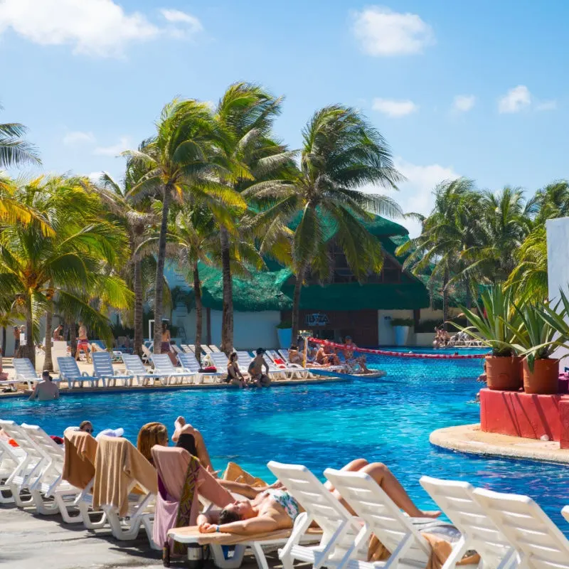 families by a pool in costa mujeres