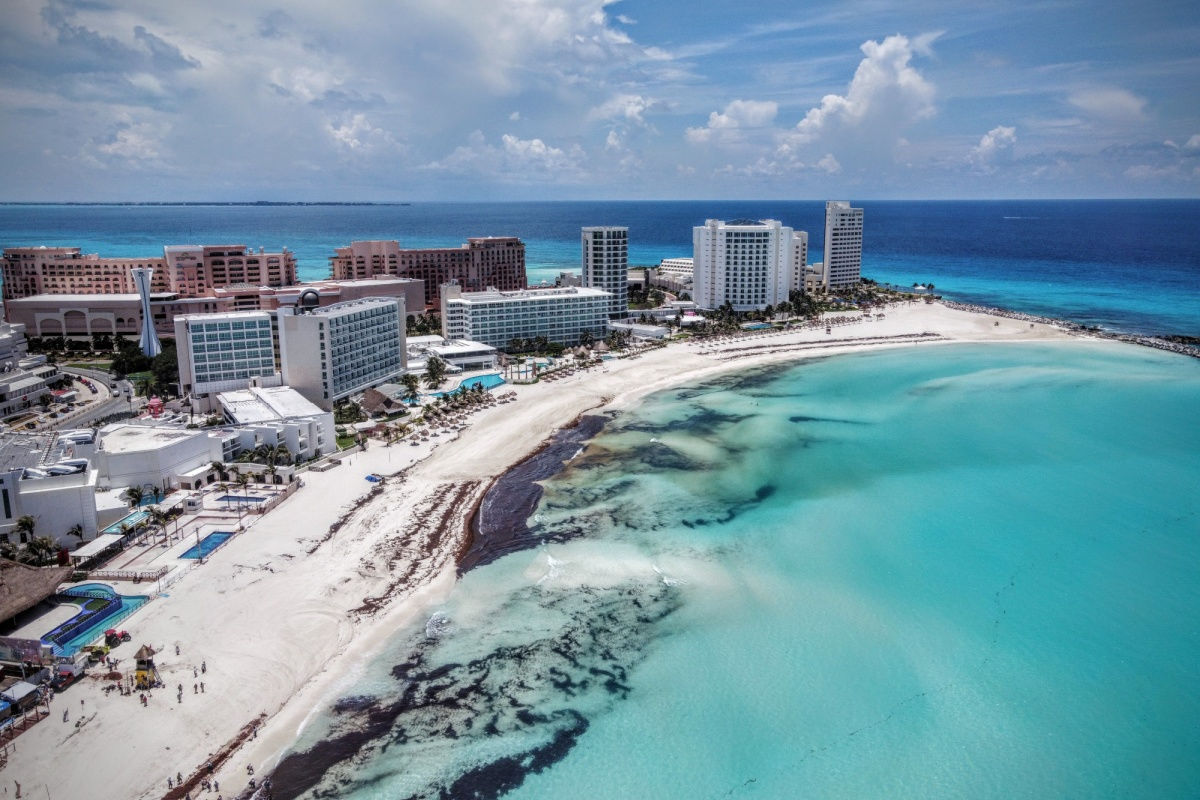 a white sand beach in Cancun full of sargassum 