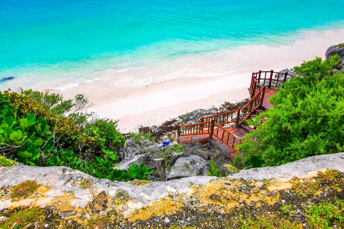 a small white sand beach in tulum 