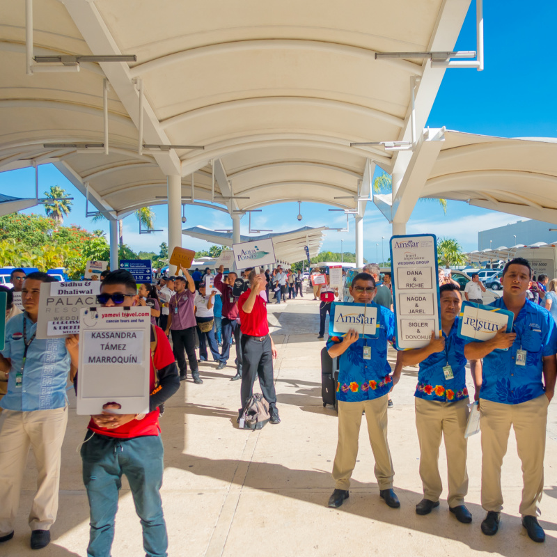 Transportation Providers with Sign Boards Standing Outside of Cancun International Airport