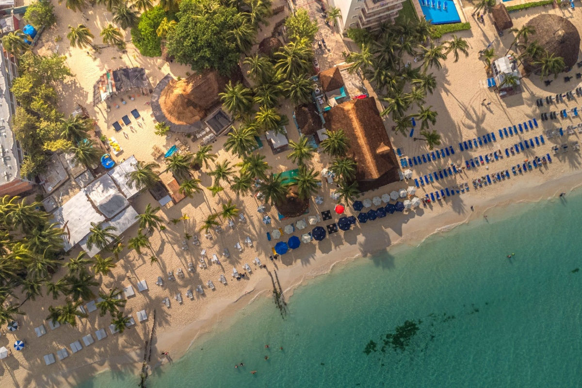 aerial view of a white sand beach in isla mujeres