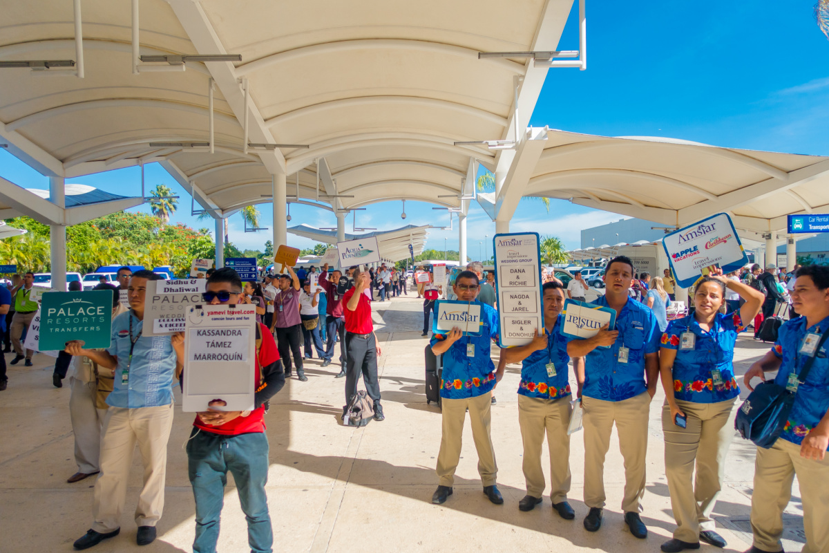 Transportation Providers with Sign Boards Standing Outside of Cancun International Airport