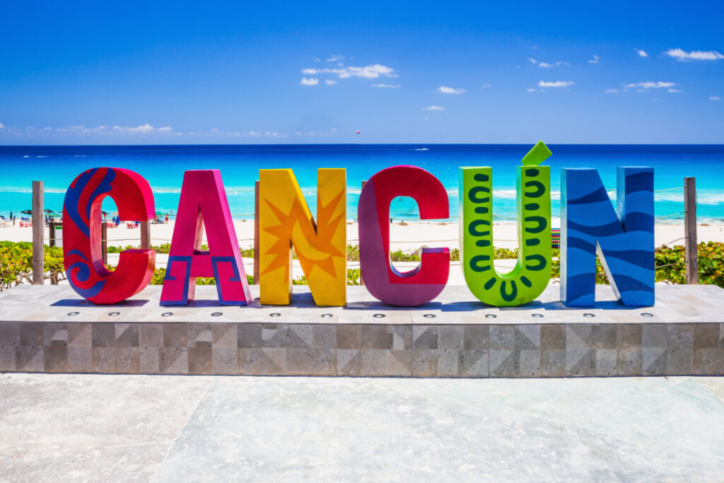 Cancun Sign Next to a Beautiful Beach