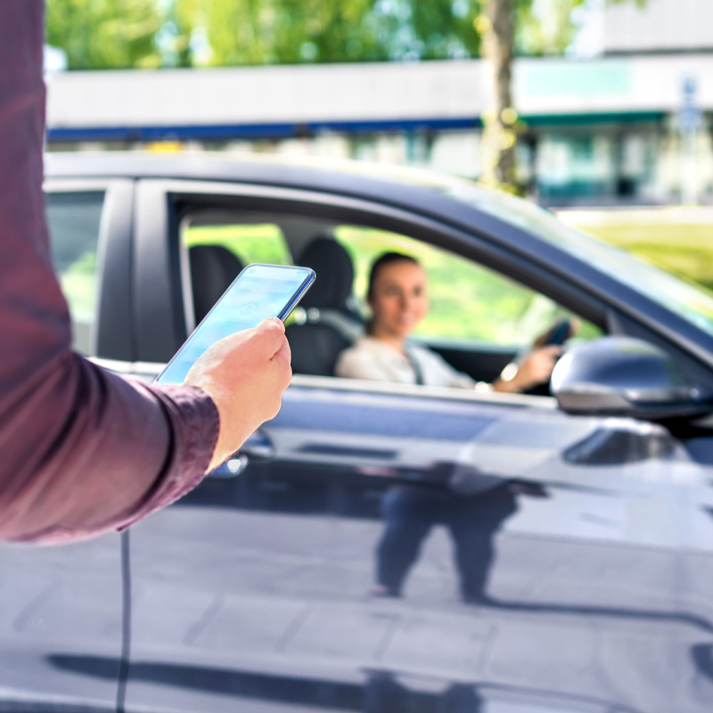 Tourist Using a Smartphone to Book a Ride