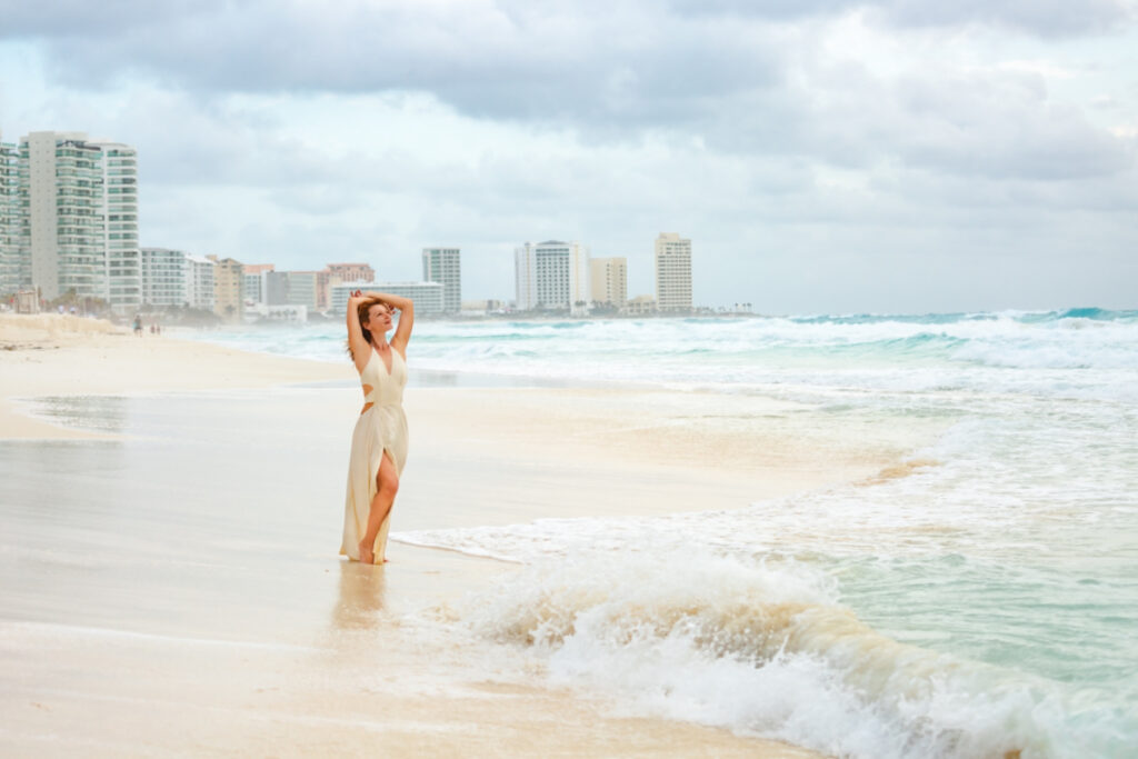 Woman on a Cancun Beach with Hotels in the Background