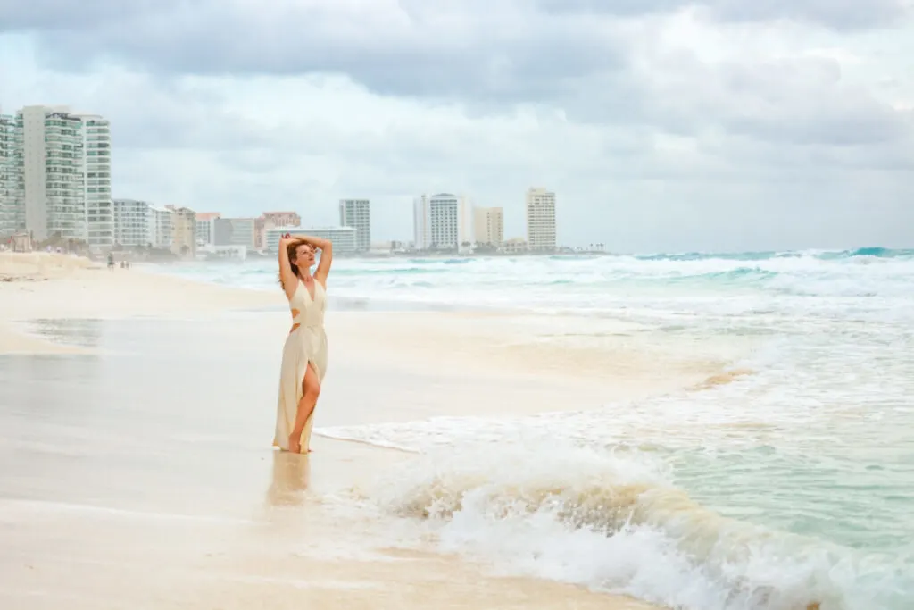 Woman on a Cancun Beach with Hotels in the Background