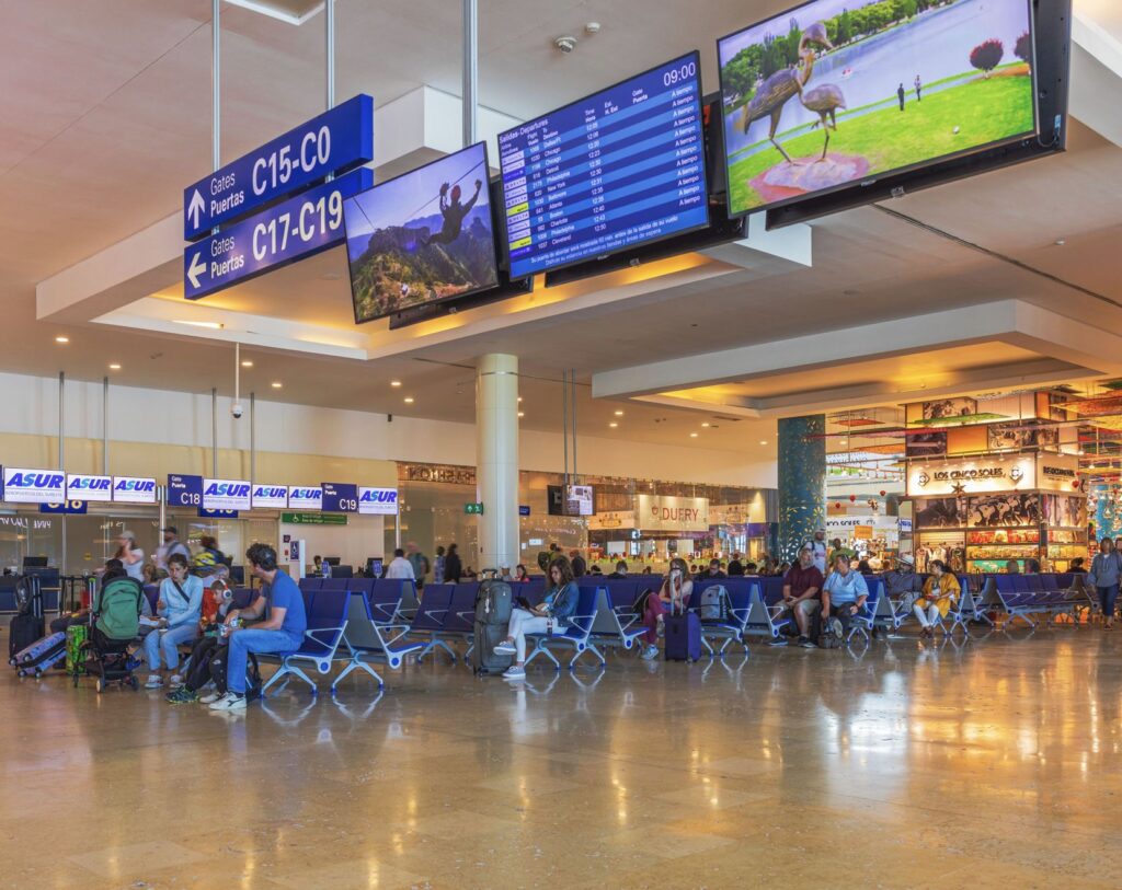 Passengers wait for flights at Cancun airport