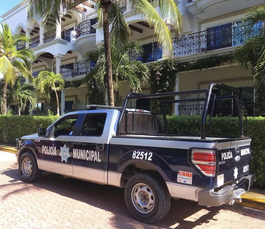 Police truck patrols Cancun Street