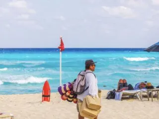 Red flag on beach with tourists