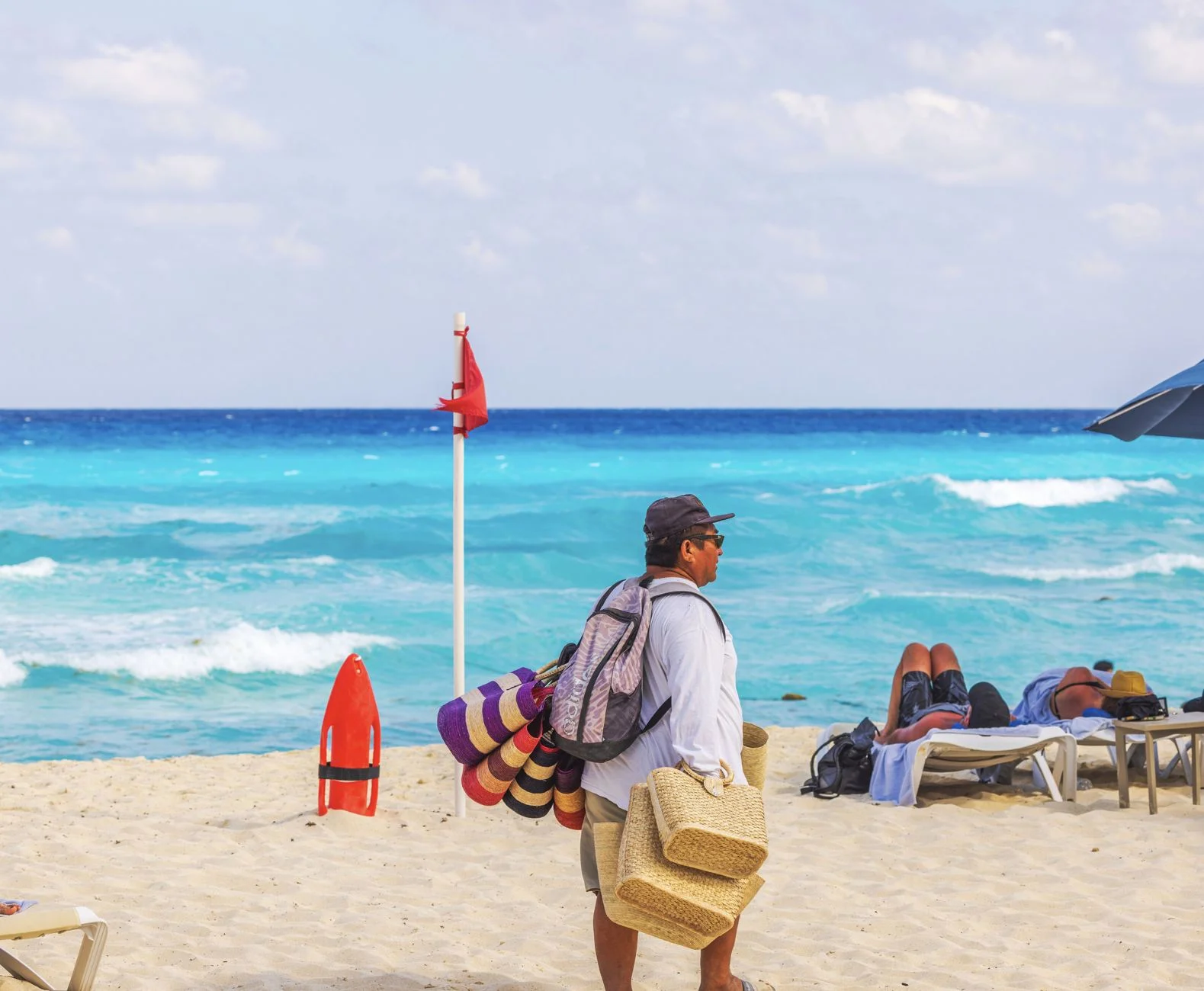 Red flag on beach with tourists