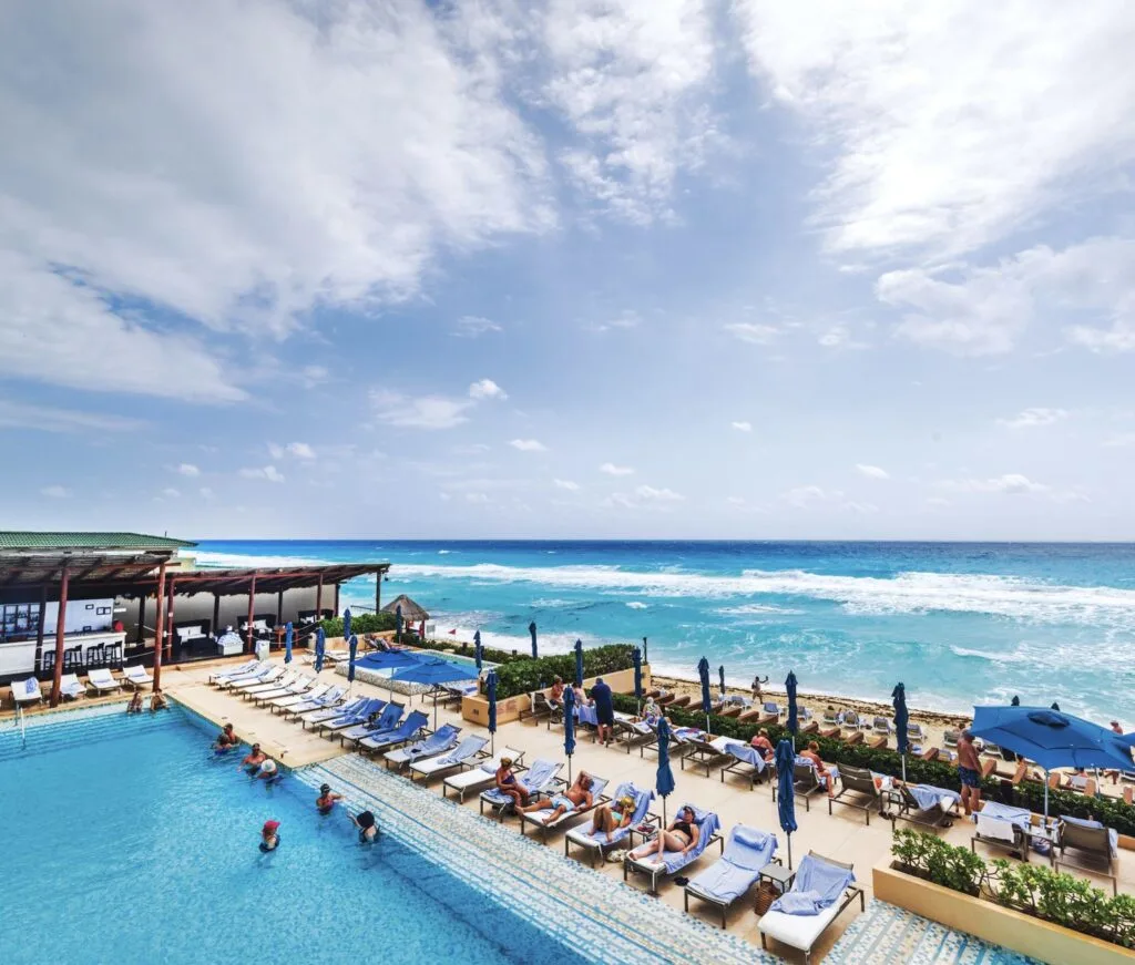 Travelers at resort pool in Cancun