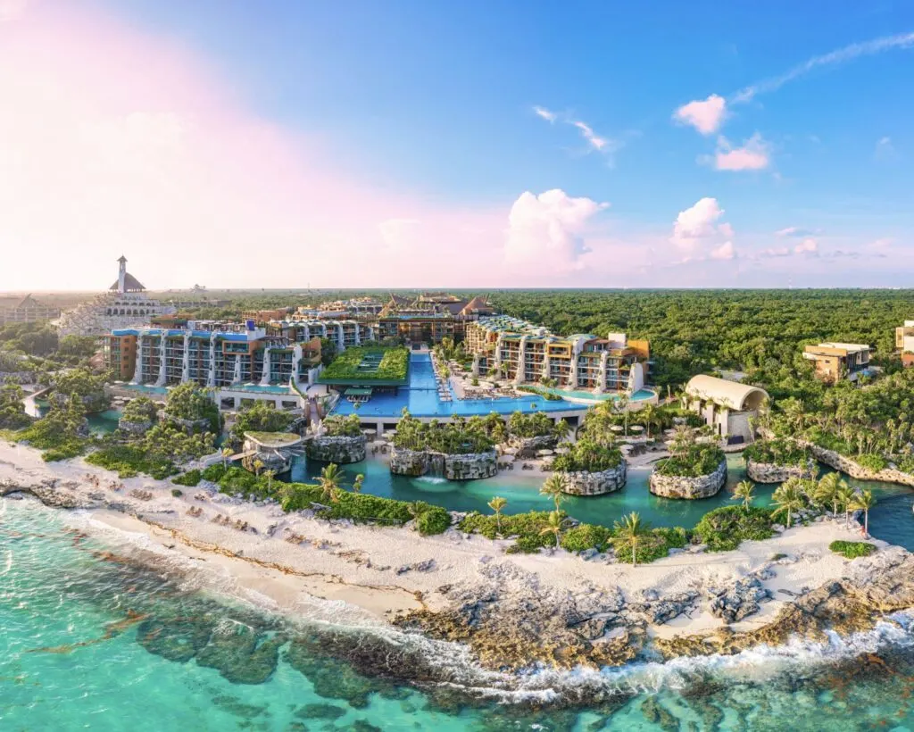Aerial tour over a luxurious 5-star hotel resort next to the beautiful beaches of Cancun with sunny weathe