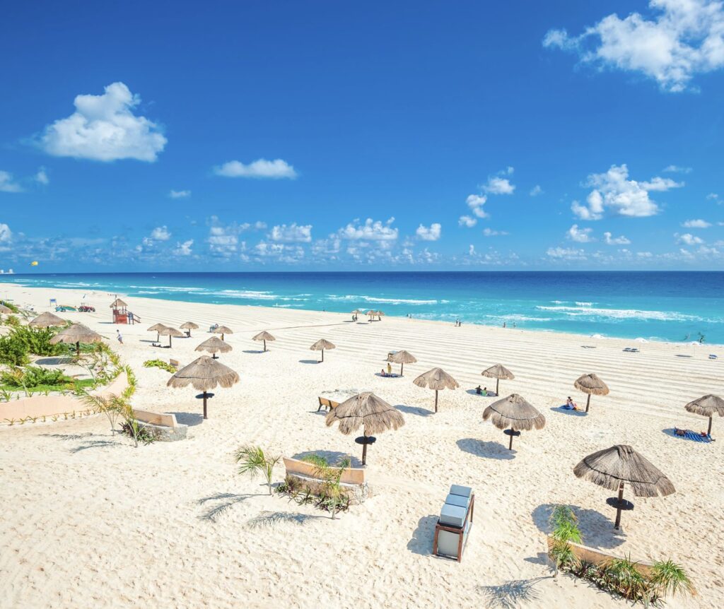 Cancun garbage bins on pristine groomed white sand beach