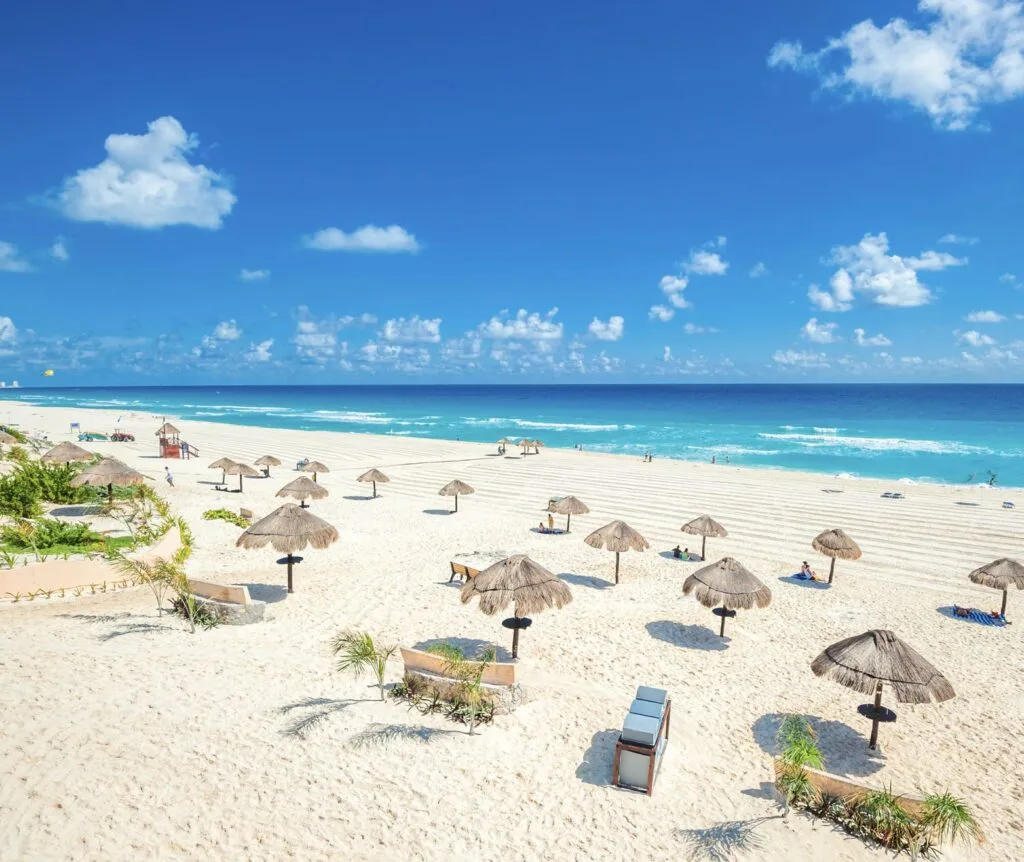 Cancun garbage bins on pristine groomed white sand beach