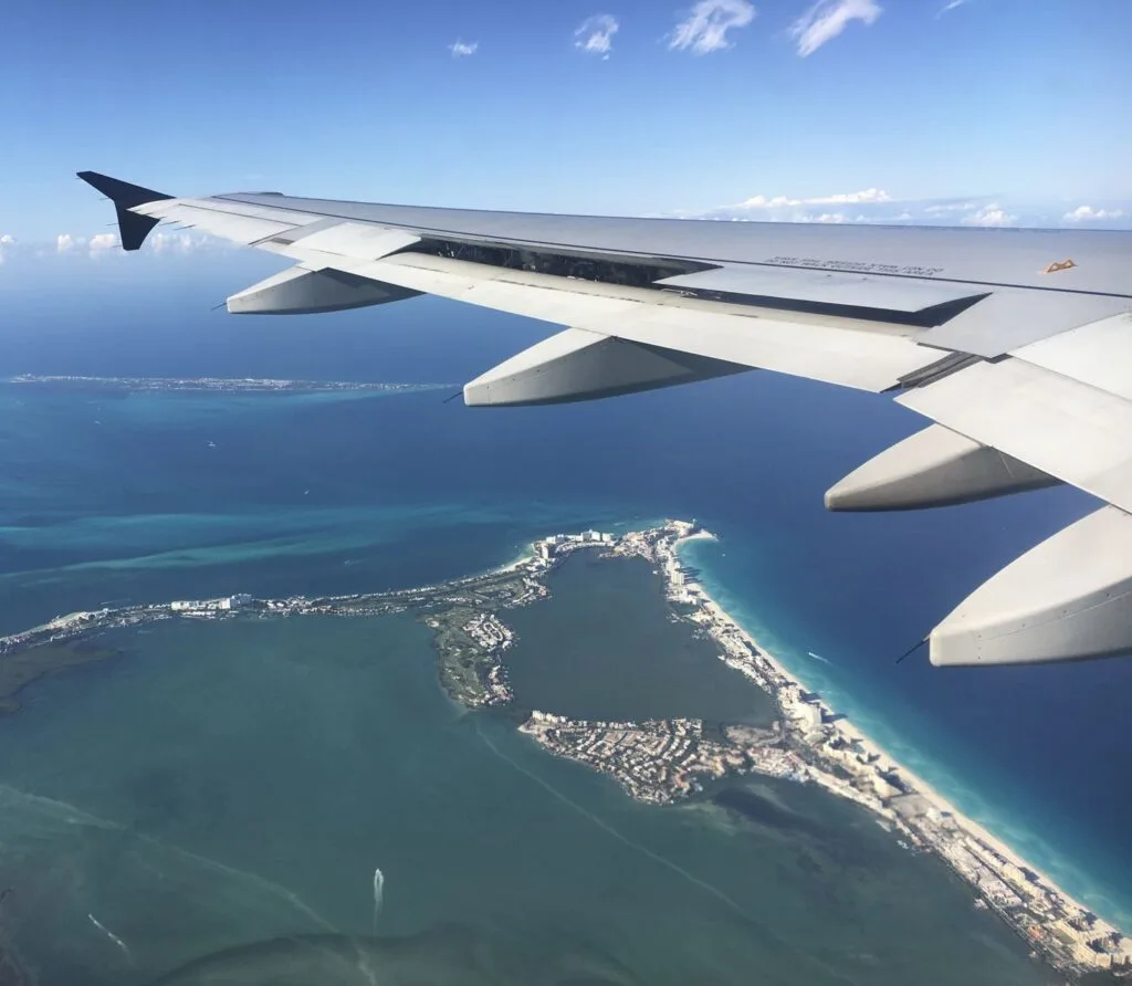 PLane flying over cancun hotel zone