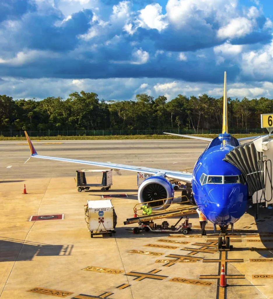 plane and vehicles at airport outside in Cancun Quintana Roo Mexico
