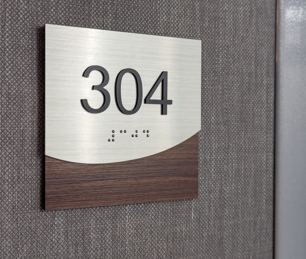 Photos of a brown and silver hotel room number 304 with braille