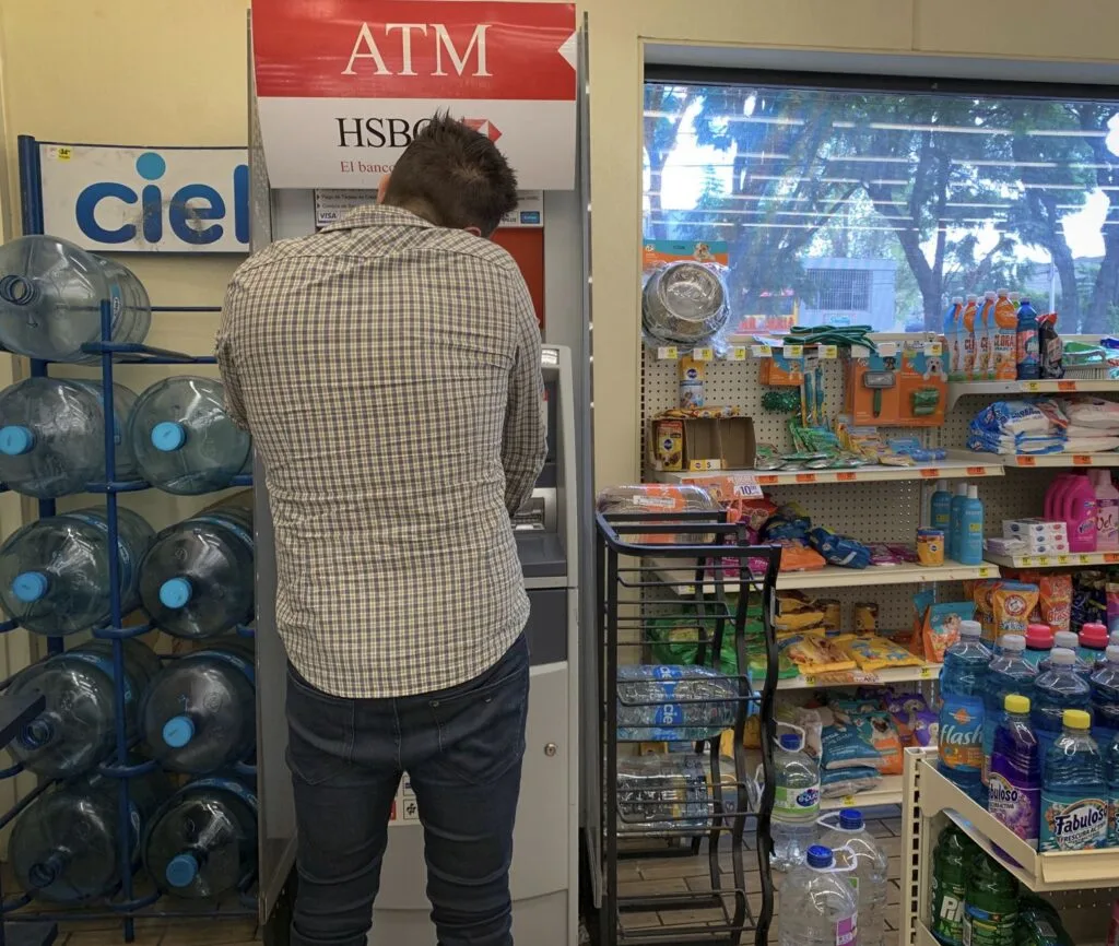 Tourist Uses Bank Machine at Oxxo