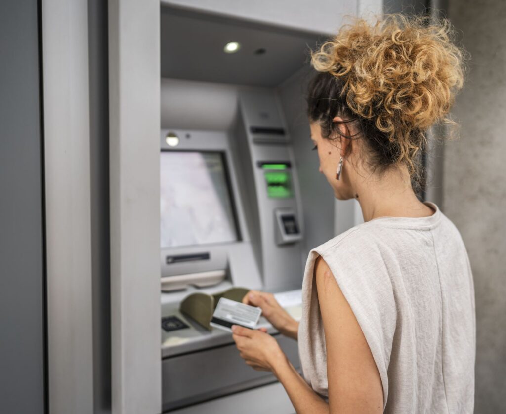 Tourist using bank atm in cancun