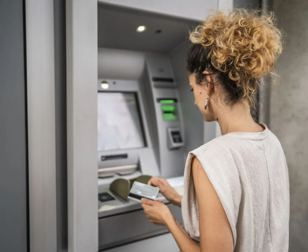 Tourist using bank atm in cancun