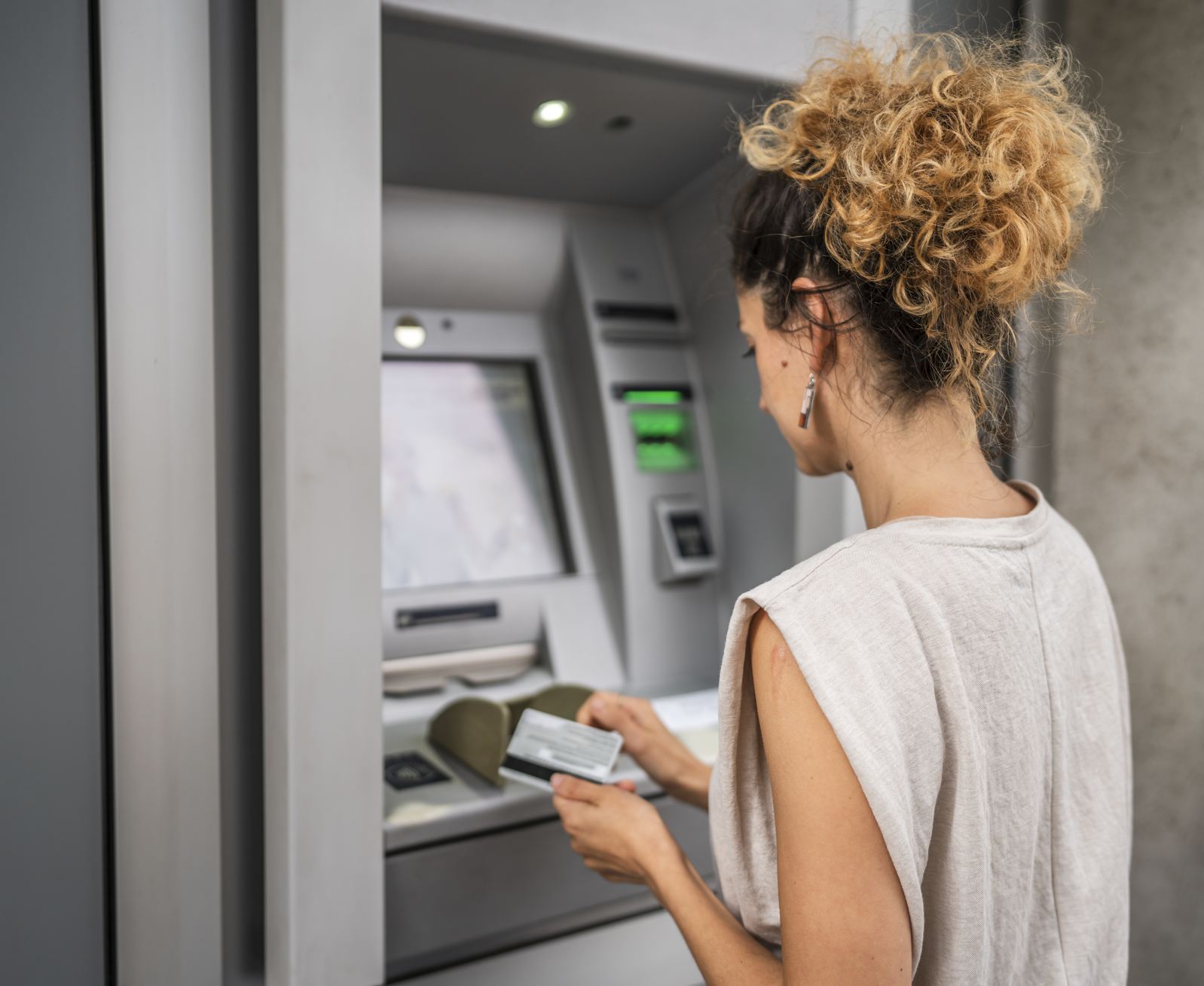 Tourist using bank atm in cancun
