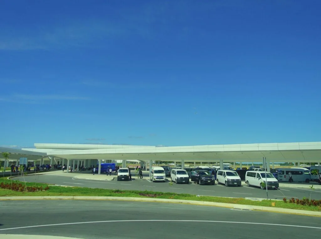 Transport shuttles wait at Cancun airport for passengers