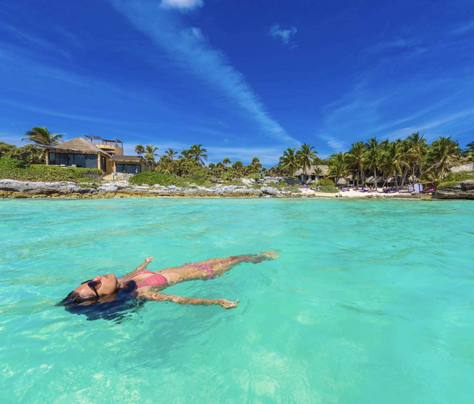 Woman swimming in water face exposed to sun