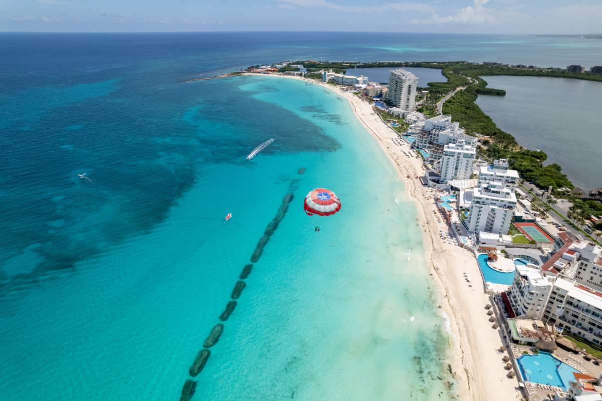Aerial view of Cancun with someone paragliding