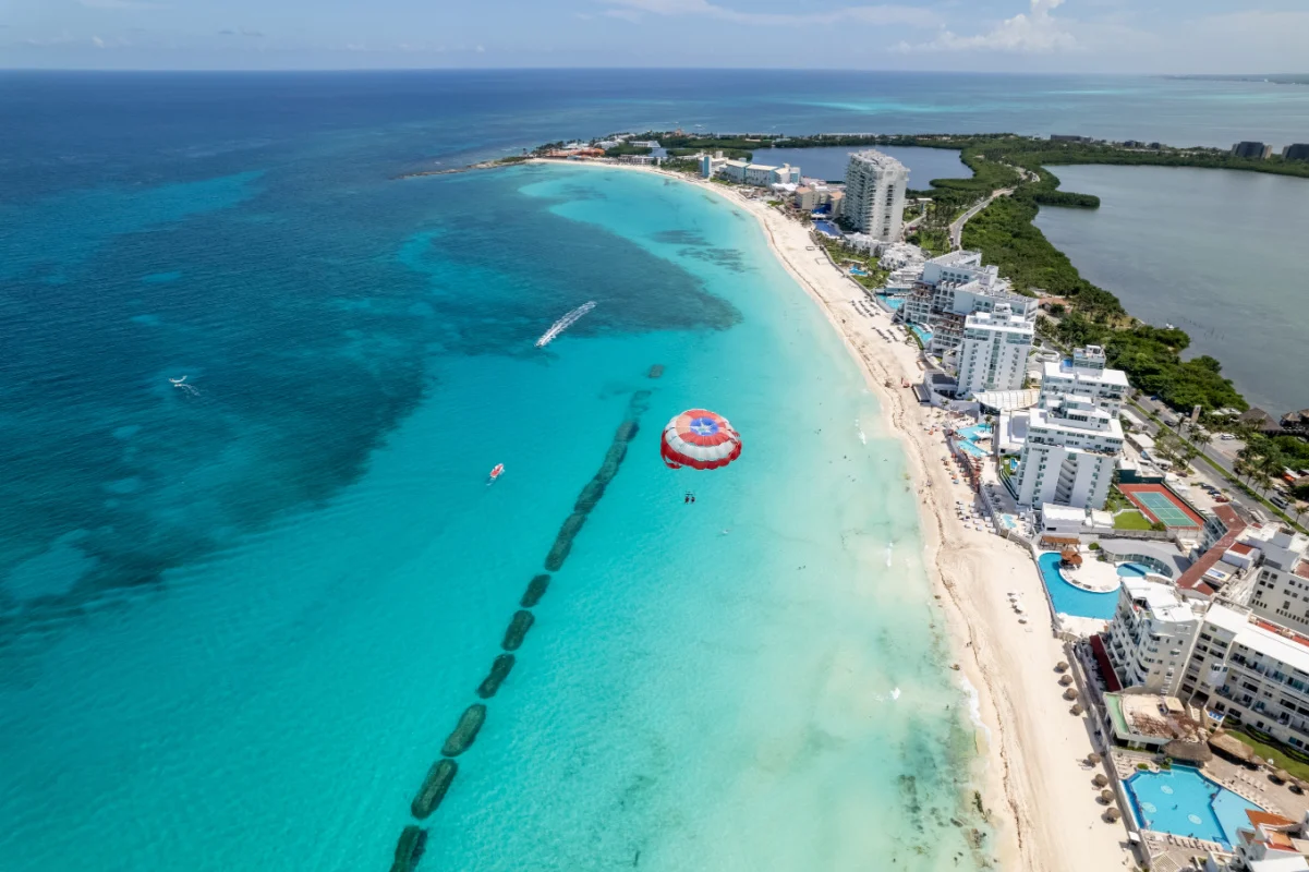 Aerial view of Cancun with someone paragliding