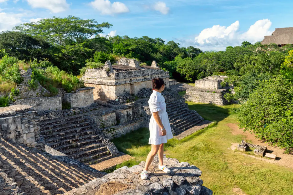Ek Balam Mayan ruins in Mexico with woman standing on the ruins