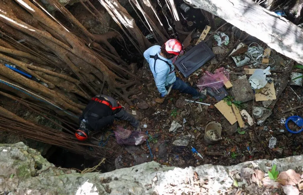 Man Cleaning Cenote At Bottom