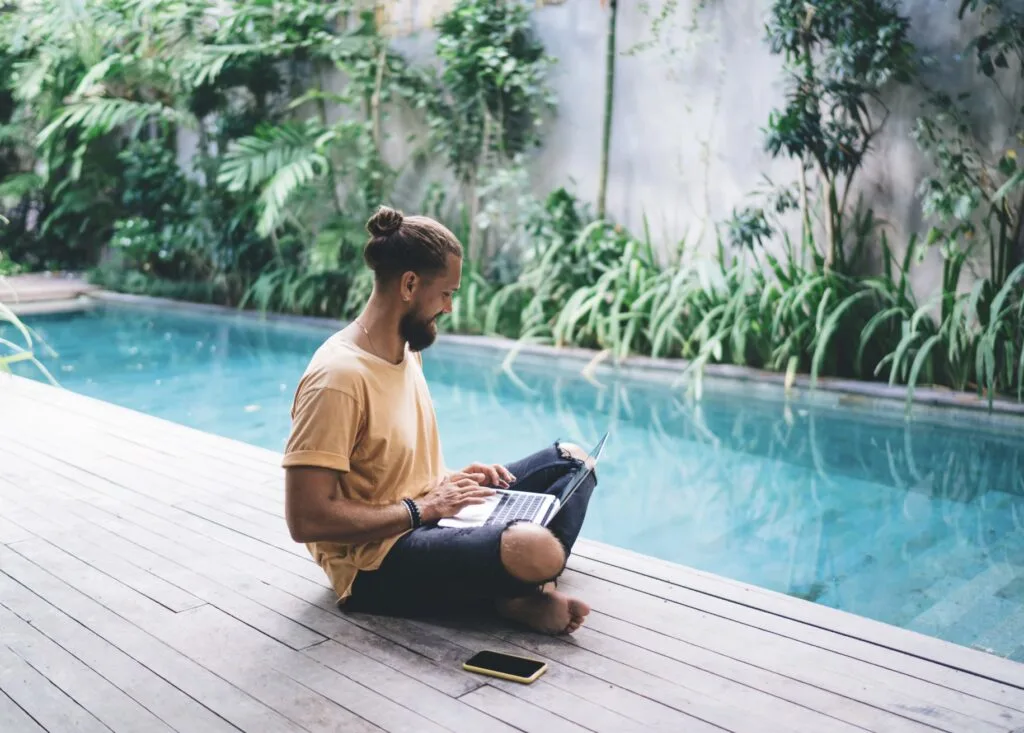 Man In Tulum on Computer by Pool